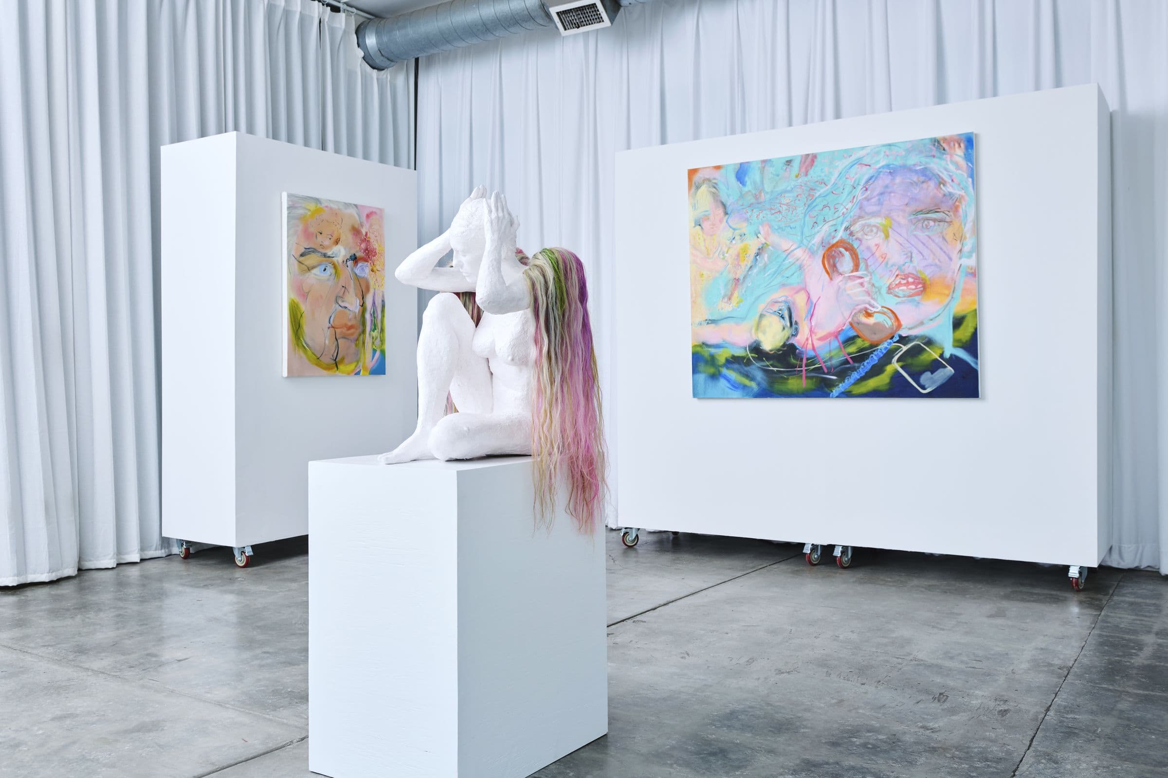 Wide view of Lola Gallery's main room in Chinatown, Los Angeles: white walls, polished concrete floor, sculpture and paintings from a group exhibition