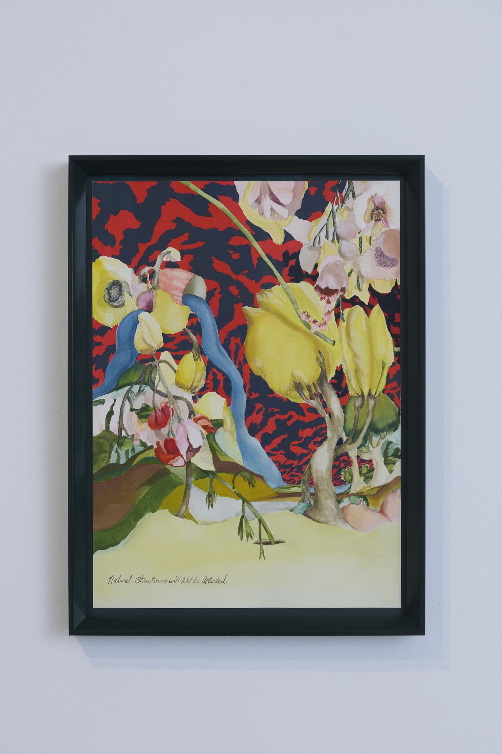 Framed watercolor painting hanging on a white gallery wall