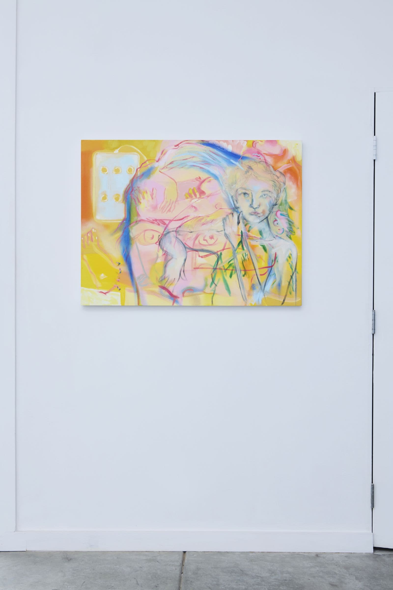 Small abstract painting hung beside a gallery doorway