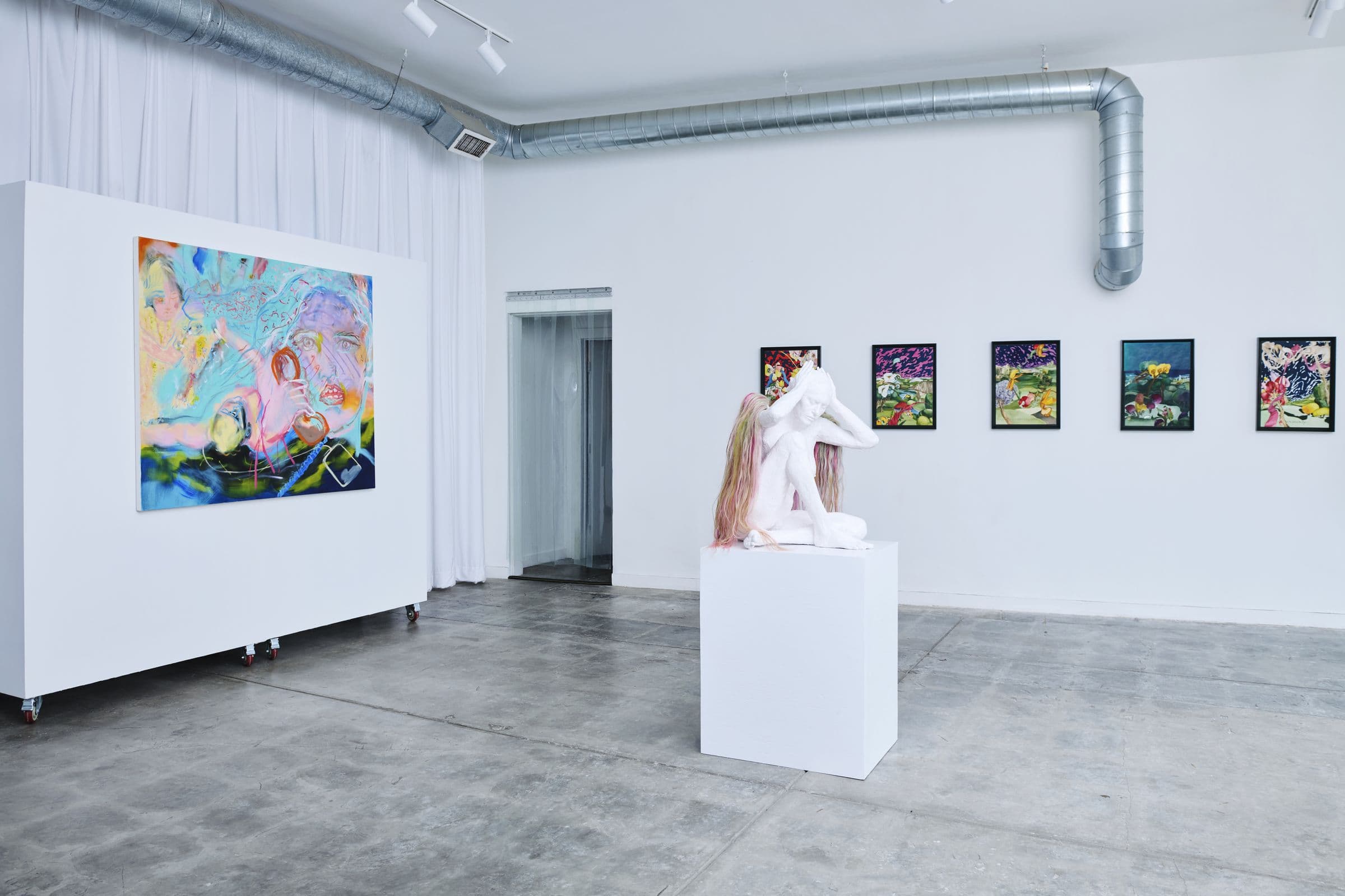 Lola Gallery's open 1,800 square foot room with movable white walls, natural light, and exhibition installation views